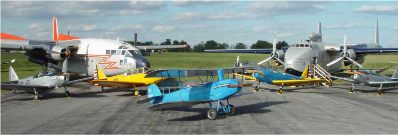 variety of Fairchild planes sitting on pavement outside