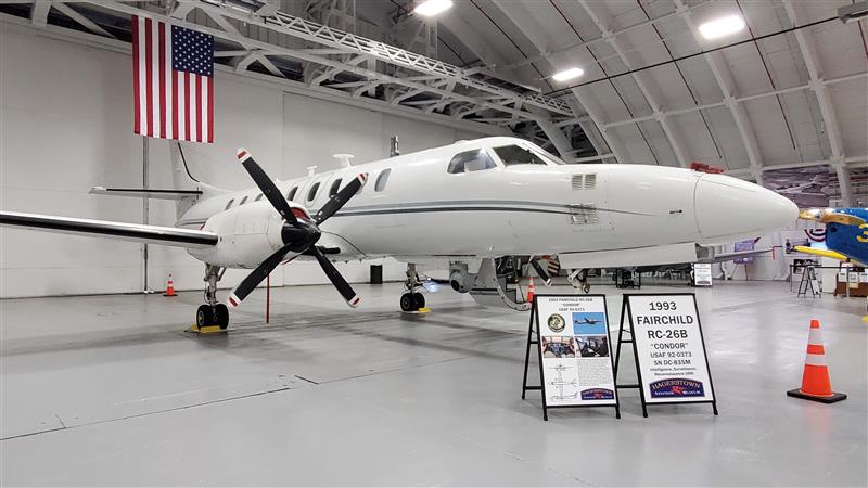 white fairchld RC-26B spy plane in dome hangar